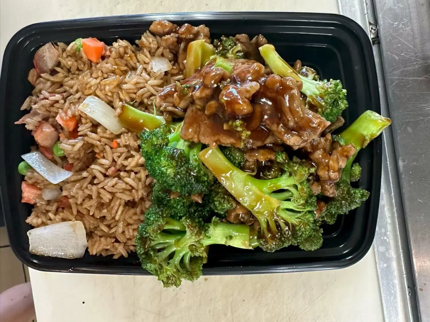 Tender beef with broccoli served alongside flavorful fried rice at Taste of China,a Chinese restaurant in Raleigh.