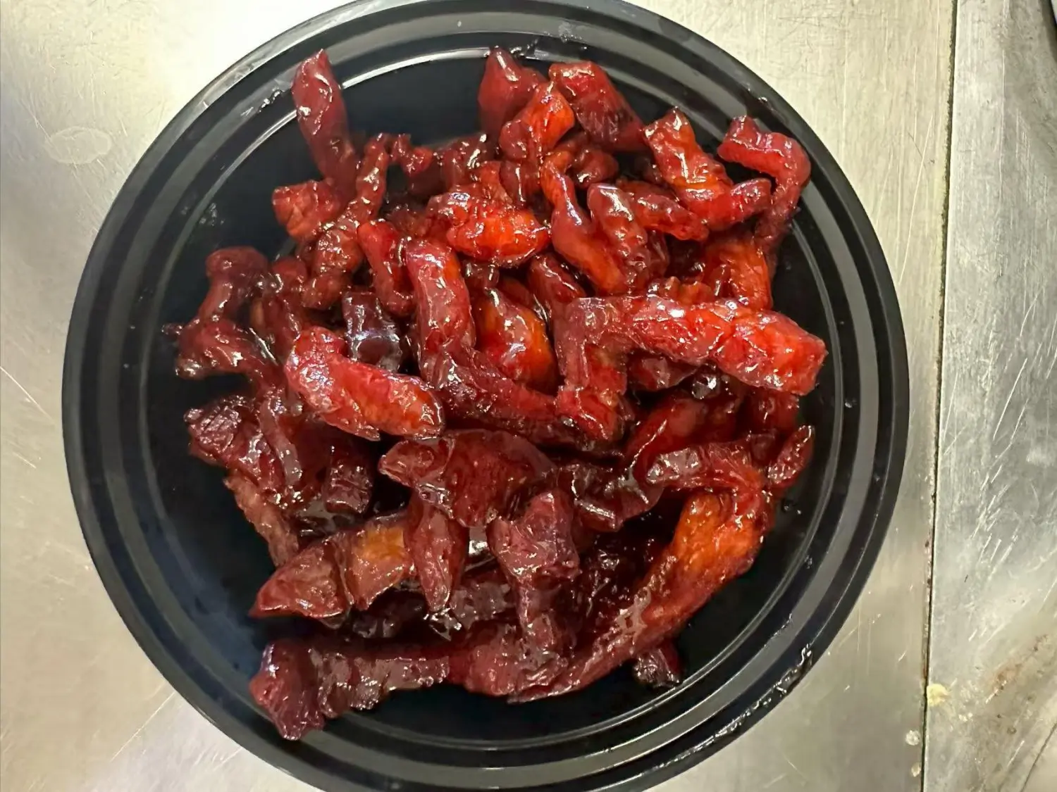 Succulent sweet and sour pork pieces coated in a glossy, tangy sauce at Taste of China,a Chinese restaurant in Raleigh.