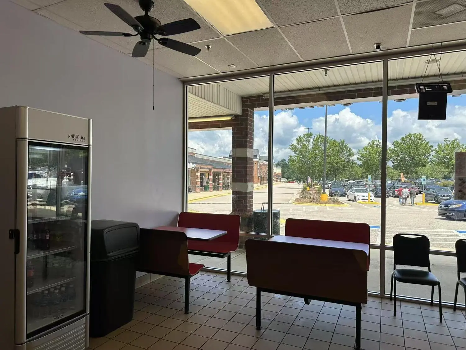 Dining area with seats, fridge, big windows at Taste of China,a Chinese restaurant in Raleigh.